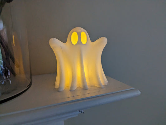 cute ghost with LED tea light on mantel