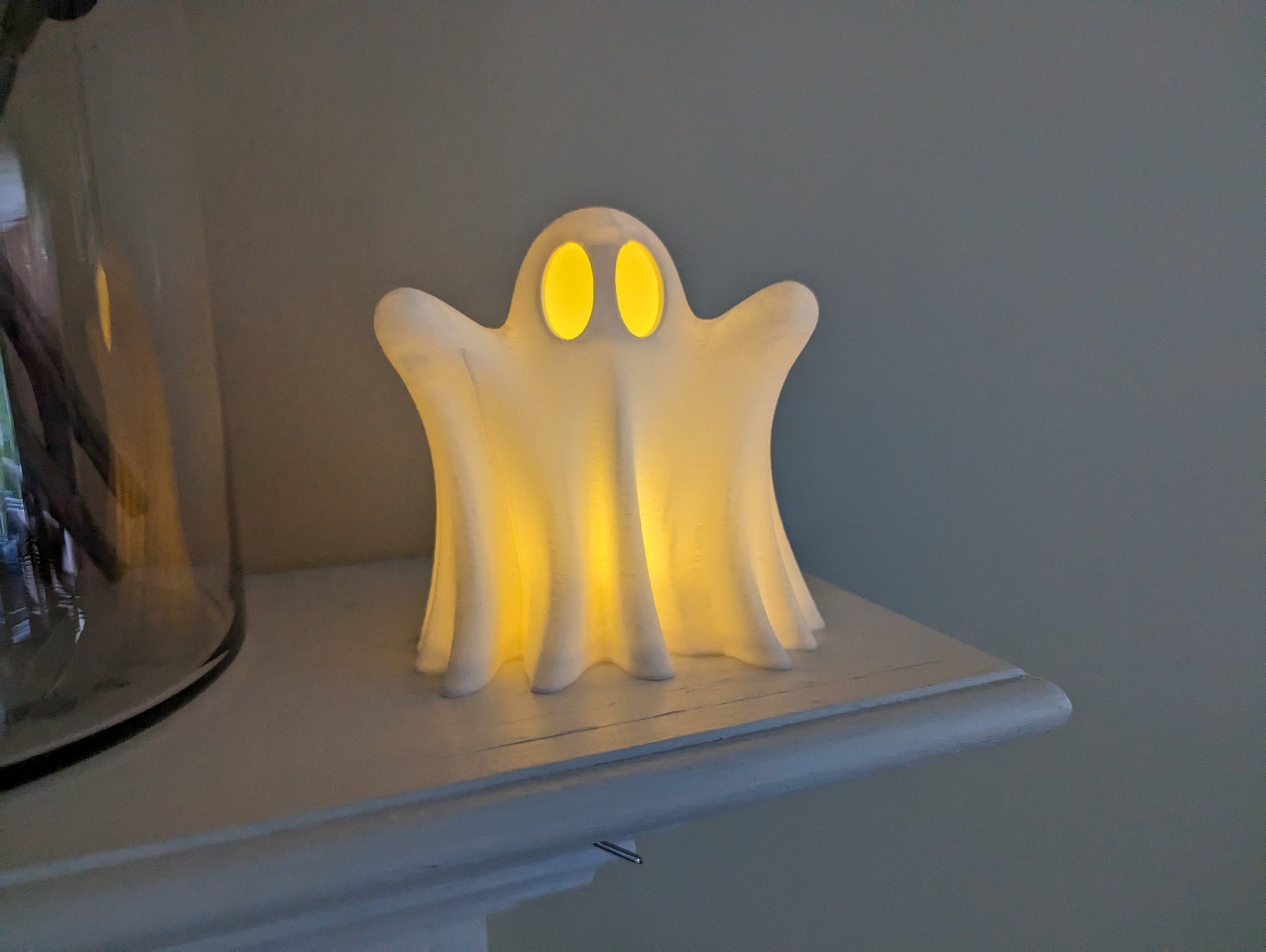 cute ghost with LED tea light on mantel
