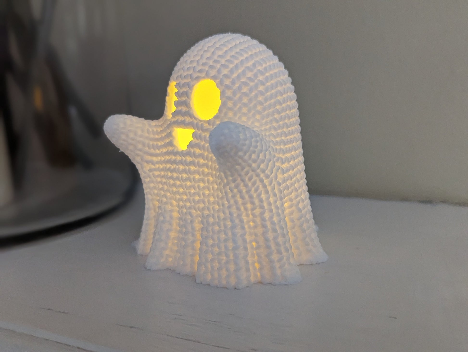 3d printed crochet textured ghost with led tea light on mantel